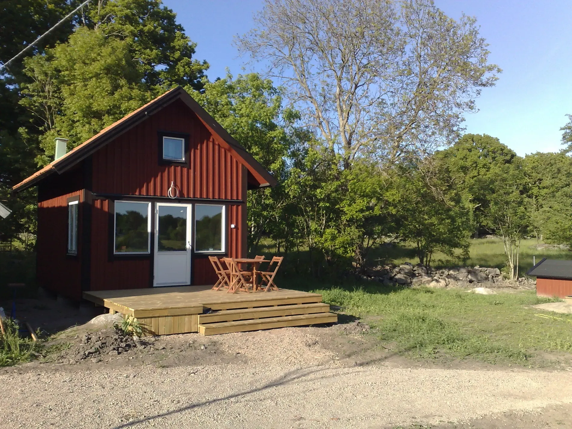Red Swedish rental house named Bravo surrounded by nature